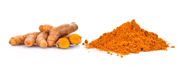 turmeric powder with turmeric root isolated on white